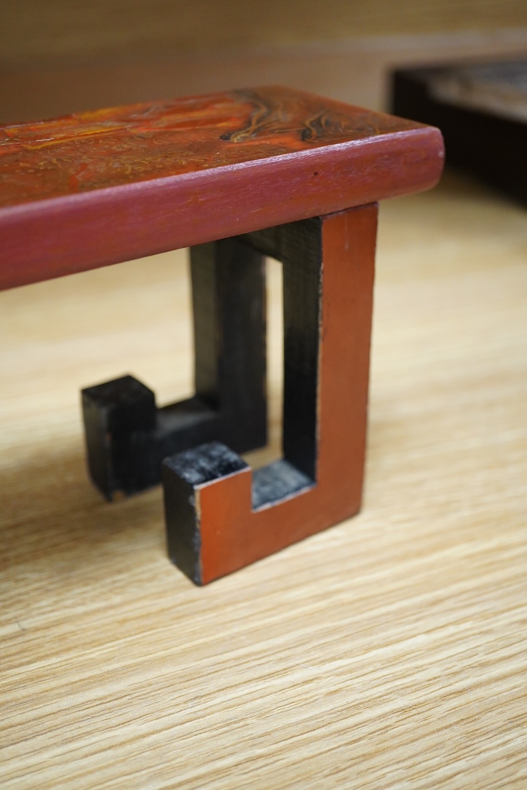 A Chinese red lacquered stand, 39cm wide